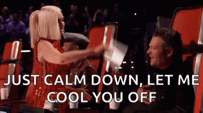 Woman In Red Dress Says Just Calm Down Let Me Cool You Off Next To Man In Black Shirt GIF