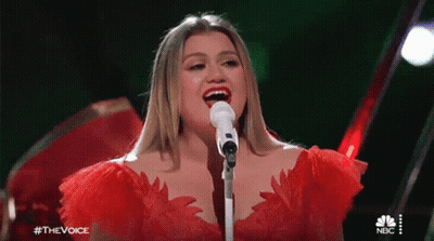 Woman In Red Dress Singing Into Microphone GIF