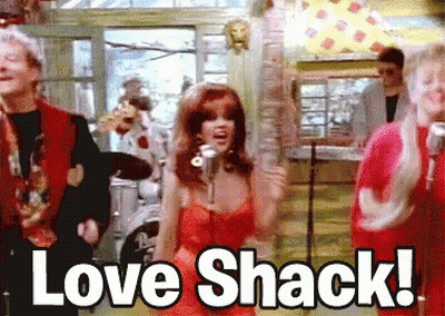 Woman in Red Dress Singing Love Shack