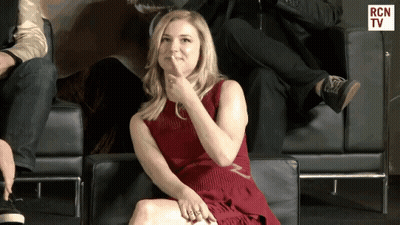 Woman In Red Dress Sitting In Chair With RCN TV GIF
