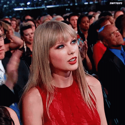 Woman In Red Dress Sitting In Crowd Swiftgifs GIF