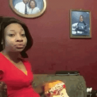 Woman In Red Dress Sitting On Couch GIF