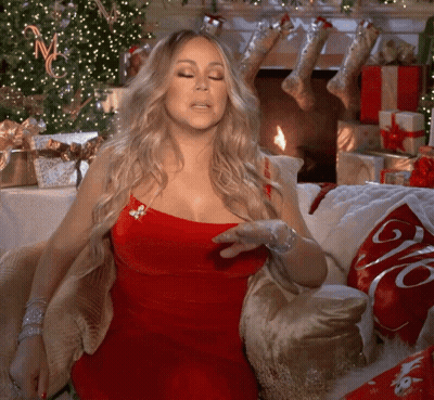 Woman In Red Dress Sitting On Couch With Coca Cola Pillow GIF