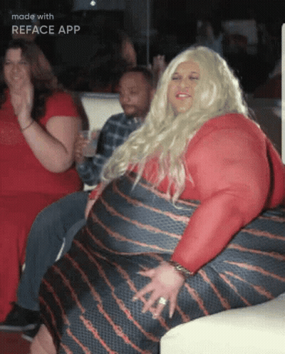 Woman In Red Dress Sitting On Couch With Reface App Text GIF