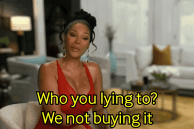 Woman in Red Dress Sitting Saying Who You Lying To We Not Buying It