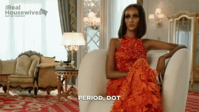 Woman In Red Dress Sitting With Period Dot GIF
