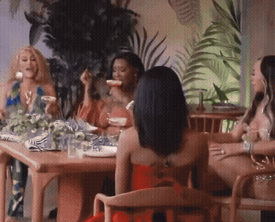 Woman In Red Dress Sitting With Three Women GIF