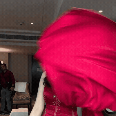 Woman In Red Dress Smiling And Waving Red Cloth GIF
