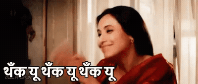 Woman In Red Dress Smiling By Window With Foreign Language Sign GIF
