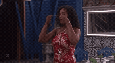 Woman In Red Dress Standing At Table GIF