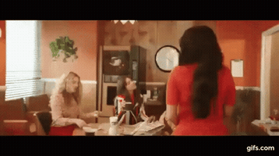 Woman In Red Dress Standing At Table GIF