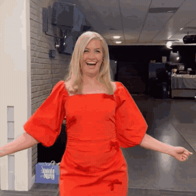 Woman In Red Dress Standing By Sewing Supply Bag GIF