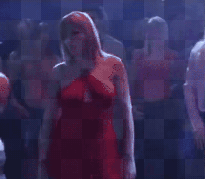 Woman In Red Dress Standing In Crowd GIF