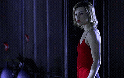 Woman In Red Dress Standing In Front Of Door GIF
