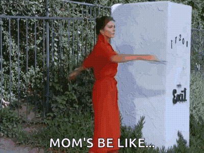 Woman In Red Dress Standing In Front Of Exit Sign GIF