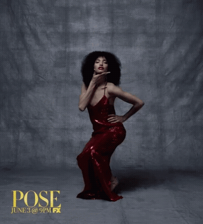 Woman In Red Dress Standing In Front Of Pose Wall GIF
