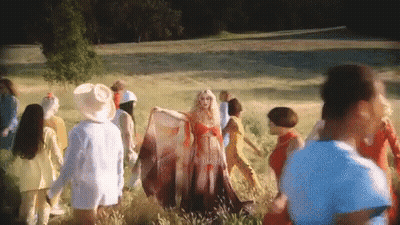 Woman In Red Dress Surrounded By People GIF