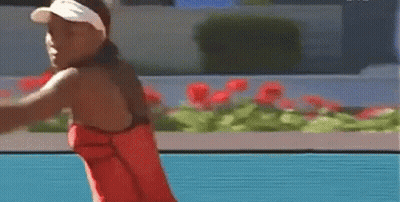 Woman In Red Dress Swinging Tennis Racquet GIF