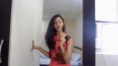 Woman In Red Dress Taking Mirror Selfie GIF