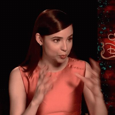 Woman In Red Dress Talking At Disney Sign GIF