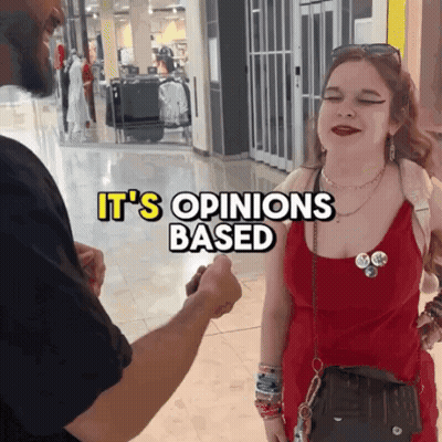 Woman In Red Dress Talking To Man In Black Shirt It's Opinions Based GIF