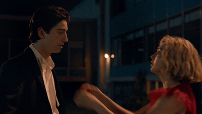Woman In Red Dress Touching Man In Suit GIF