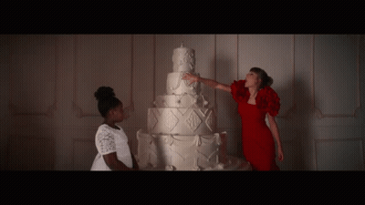 Woman In Red Dress Touching White Cake GIF