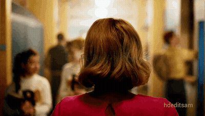 Woman In Red Dress Walking Down Hallway GIF