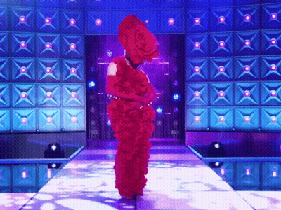 Woman In Red Dress Walking Down Stage GIF