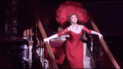 Woman In Red Dress Walking Down Stairs GIF