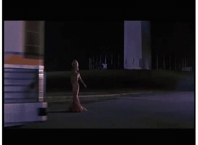 Woman In Red Dress Walking Down Street GIF