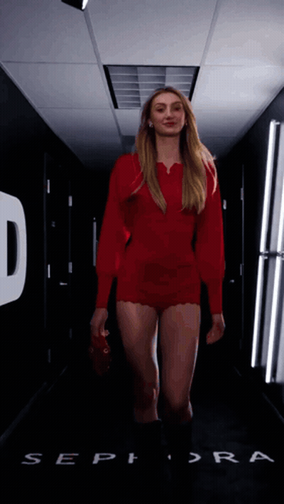Woman In Red Dress Walking Past Sephora Sign GIF