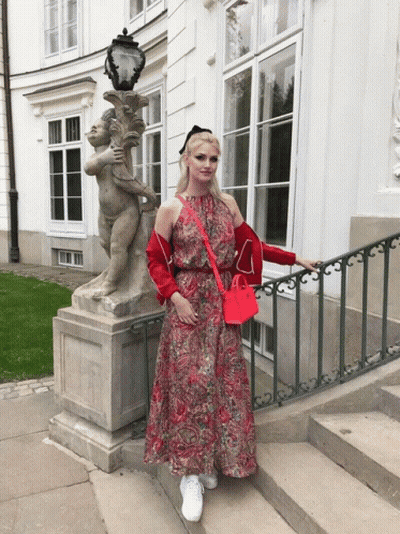 Woman In Red Dress With Cherub Statue GIF