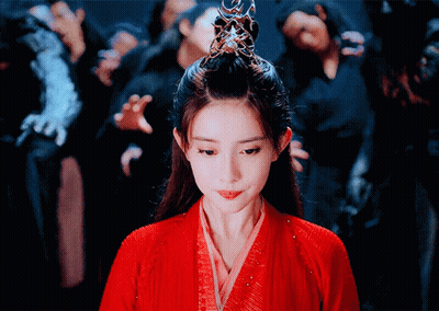 Woman In Red Dress With Crown In Front Of Crowd GIF