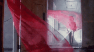 Woman In Red Dress With Red Cloth Blowing GIF