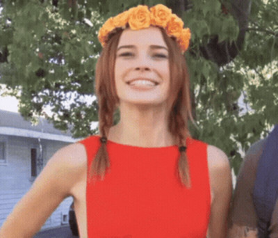 Woman In Red Dress With Yellow Rose Wreath Smiling GIF