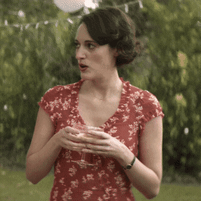 Woman In Red Floral Dress Holding Wine GIF