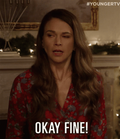 Woman In Red Floral Dress Holding Wine Says Okay Fine GIF