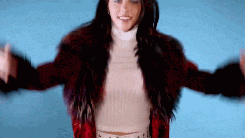 Woman In Red Fur Coat And White Turtleneck GIF