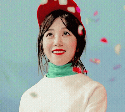 Woman In Red Hat And Green Turtleneck Smiling GIF
