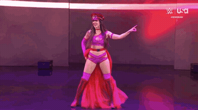 Woman In Red Hat And Purple Outfit Pointing GIF