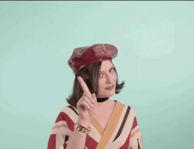 Woman In Red Hat And Striped Shirt Pointing Up GIF
