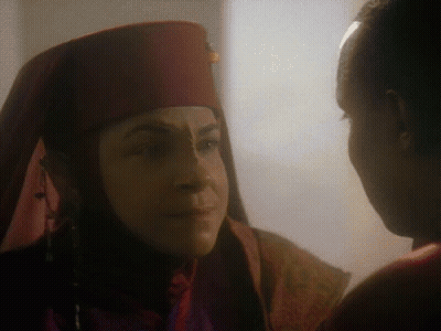Woman In Red Hat Looking At Another Woman GIF