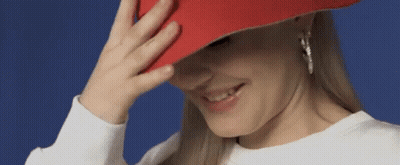 Woman In Red Hat Smiling Covering Face GIF