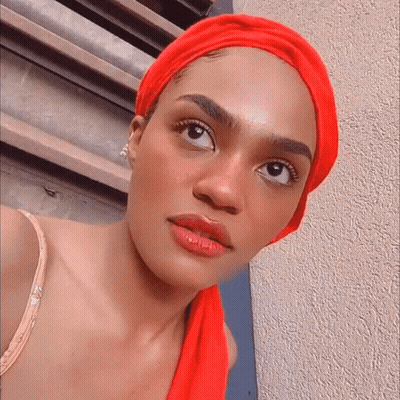 Woman In Red Head Scarf Looking Sideways GIF