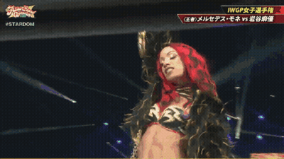 Woman In Red Head Scarf Next To Woman In Gold Outfit Stardom GIF