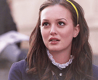 Woman In Red Headband Talking To Another GIF