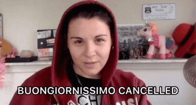 Woman In Red Hoodie Says Buongiornossimo Cancelled Beside Stuffed Unicorn GIF