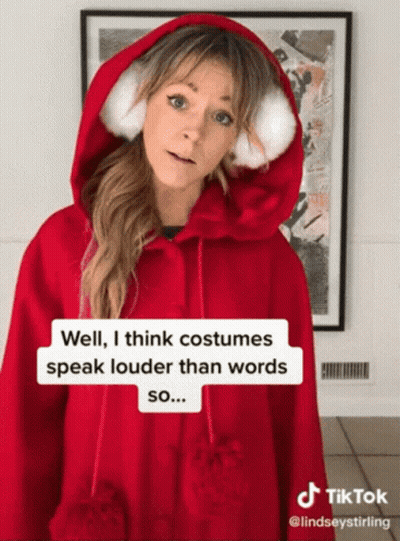 Woman In Red Hoodie Says Costumes Speak Louder GIF