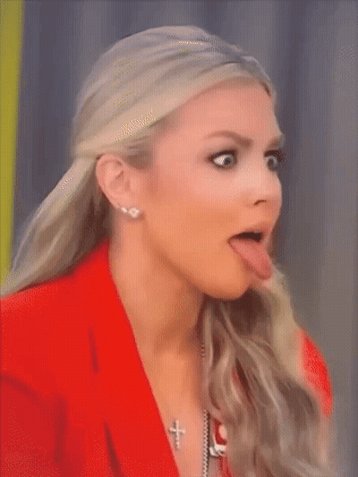Woman In Red Jacket And Cross Necklace Sticking Tongue Out GIF